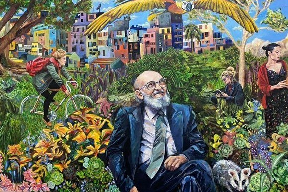 Elaborate mural of Paulo Freire in a colorful garden, with parrot, cyclist, and readers