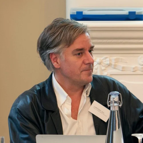 Jens Lowitzsch, seated at a conference table